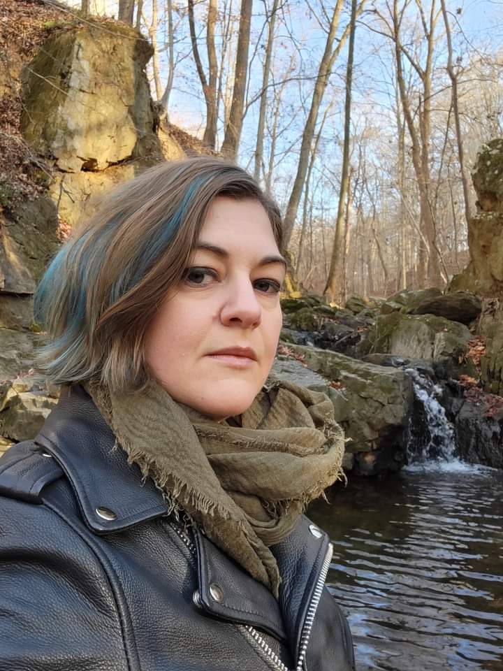 head shot, pale person with blond and blue hair, outside in winter